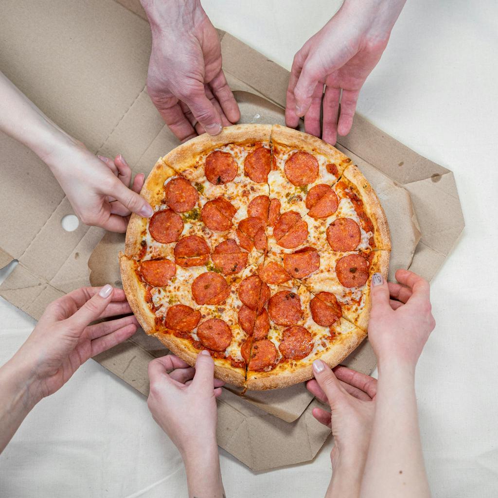 Person Holding Pizza With Cheese